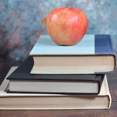 An apple on top of a stack of books